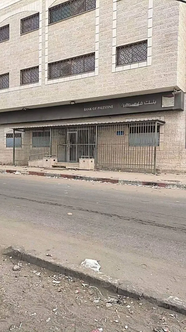 Bank of Palestine branch in Deir al-Balah, central Gaza Strip, closed due to stray bullets reaching the headquarters from east of Deir al-Balah, with clients redirected to the Nuseirat branch