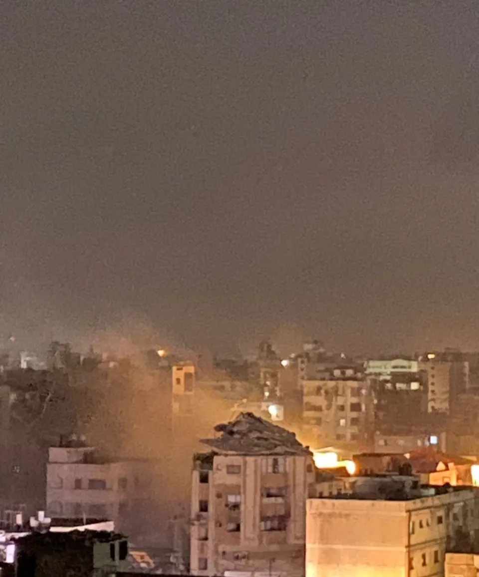 Occupation aircraft target a house after its evacuation in the vicinity of Al-A'ilat Pharmacy, at the beginning of Al-Nasr Street, west of Gaza City. — Image 1